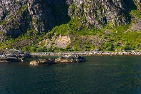 Dramatic Mountain Cliffs and Turquoise Waters in Lofoten Norway 写真素材