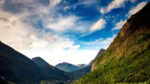 Dramatic Mountain Landscape with Blue Sky and Fluffy Clouds Stock Footage 308635664