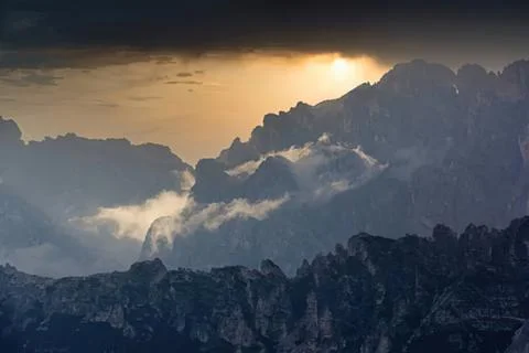 Dramatic mountain landscape with clouds and sunset sky Stock Photos