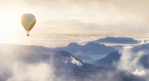 Dramatic Mountain Landscape covered in clouds and Hot Air Balloon Flying Stock Illustration