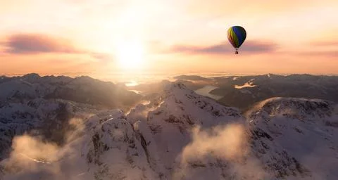Dramatic Mountain Landscape covered in clouds and Hot Air Balloon Flying Stock Illustration