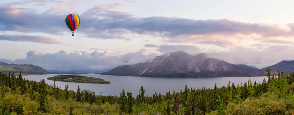 Dramatic Mountain Landscape covered in clouds and Hot Air Balloon Flying. Stock Illustration