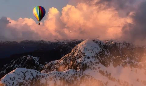 Dramatic Mountain Landscape covered in clouds and Hot Air Balloon Flying. Stock Illustration