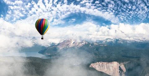 Dramatic Mountain Landscape covered in clouds and Hot Air Balloon Flying. Stock Illustration
