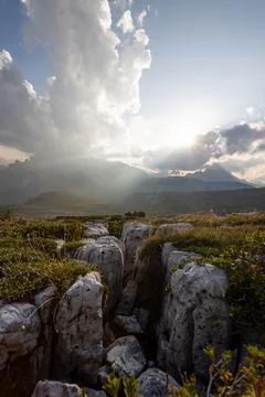 Dramatic Mountain Landscape in the Dolomites with Sun Rays and Rocky Foreground Stock Photos