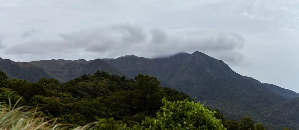 Dramatic Mountain Landscape with Rolling Clouds and Lush Greenery Creating .. Stock Photos