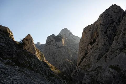 Dramatic mountain landscape with sunlight and rocky cliffs from Ruta del Care Stock Photos