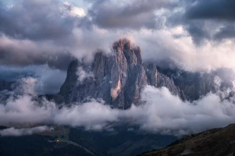 Dramatic mountain peak in clouds at sunset in Dolomites, Italy Stock Photos