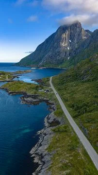Dramatic Mountain Peak Over Coastal Road in Lofoten Islands Norway Stock Photos