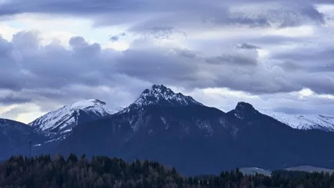 Dramatic mountain peak timelapse with fast moving storm clouds over snowy alpine Stock-Footage 327521852