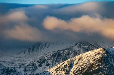 Dramatic mountain peaks and clouds in winter 스톡 사진