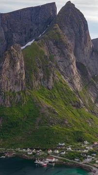 Dramatic Mountain Peaks Over Coastal Village in Lofoten Norway Fotos de archivo