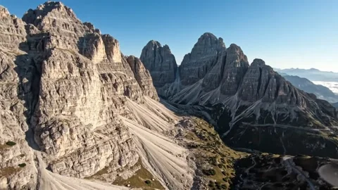 Dramatic mountain peaks under a clear blue sky Video stock 333075790