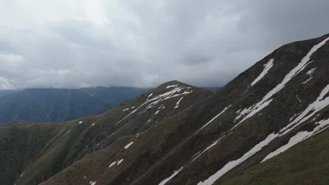 Dramatic mountain peaks under cloudy sky Stock Footage 345388122