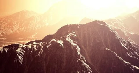 Dramatic mountain range under bright sun in an arid landscape Illustrazione stock