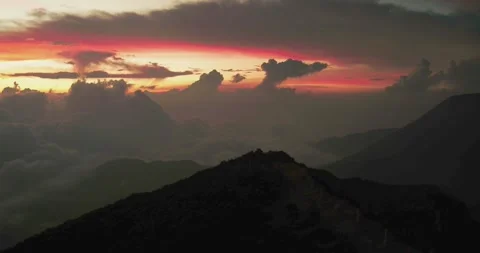 Dramatic Mountain Silhouette with Volcanic Atmosphere Stock Footage 329077706