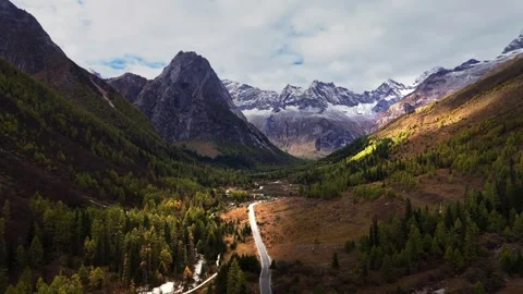 Dramatic Mountain Valley Landscape with Winding Road and Autumn Colors Tibet Stock Footage 346570552