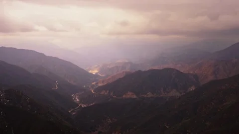 Dramatic mountain valley moody purple pink atmospheric scenic Stock Footage 329544435