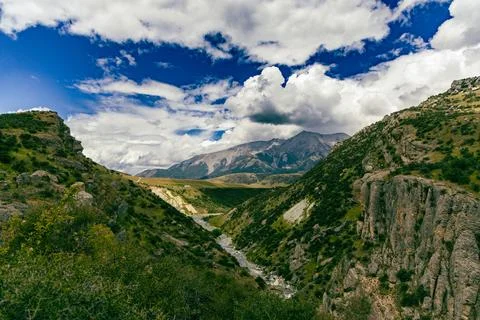 Dramatic Mountain Valley River Under Storm Clouds Stock Photos