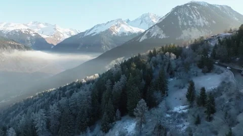 Dramatic Mountain Views with Frosted Forest and Winding Road 動画素材 334264910