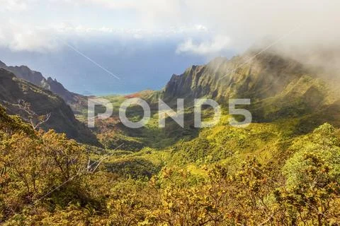 Dramatic mountainous terrain and colourful foliage on a Hawaiian island with a v Stock Photos