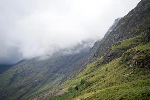 Dramatic mountains covered in clouds and mist in Glencoe valley, Scotland Fotos Stock