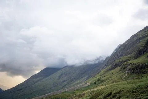 Dramatic mountains covered in clouds and mist in Glencoe valley, Scotland Fotos Stock
