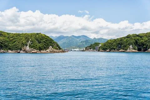 Dramatic mountains covered with lush greenery on the coast of Pacific Ocean.. Stock Photos