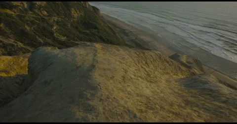 Dramatic moving aerial view over mountain tops and ocean. Stock Footage 54596545
