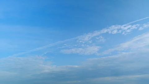 Dramatic moving white cumulus and cirrocumulus clouds or puffy fluffy cloudscape Stock Photos