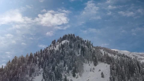 Dramatic Nature 4k video of Moving Clouds and Blue Sky Over alpine peak Video stock 330623352