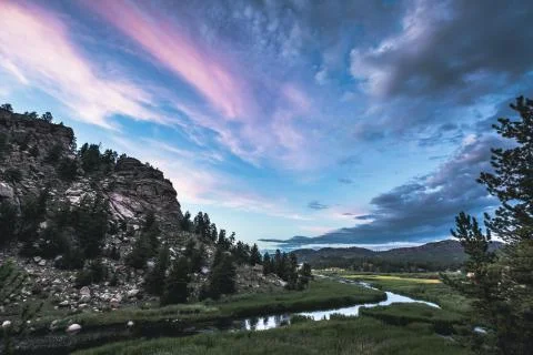 Dramatic nature scene under blue sky and vibrant clouds Stock Photos