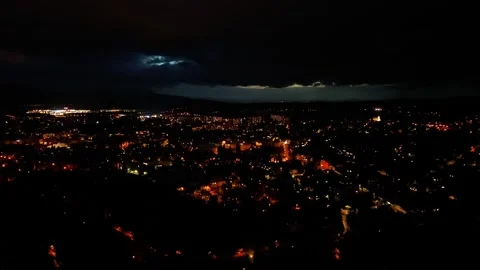 A Dramatic Night Cityscape Featuring Striking Lightning and Dazzling City Stock Footage 318687522