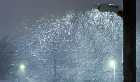 A dramatic night scene of a heavy blizzard, with a street light illuminatin.. Stock Photos