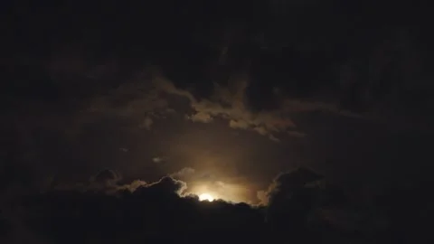 Dramatic night sky with moon obscured by dark stormy clouds Stock Footage 309660904