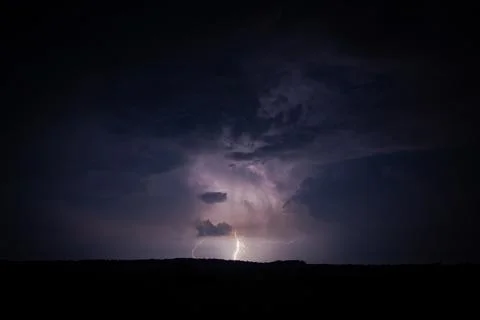 Dramatic Night Thunderstorm with Powerful Lightning Strike Stock Photos