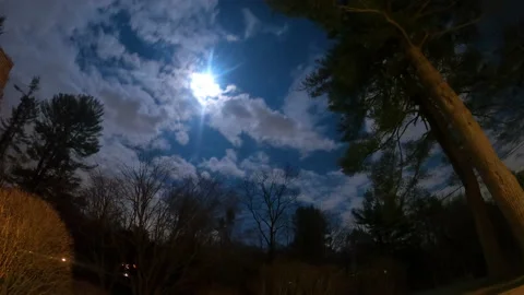 Dramatic Night timelapse of glowing moon shrouded behind fast moving clouds. Stock Footage 147804481