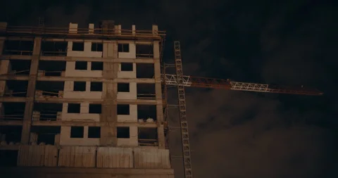 Dramatic night view of large concrete building in construction, dark night sk Stock Footage 123705804