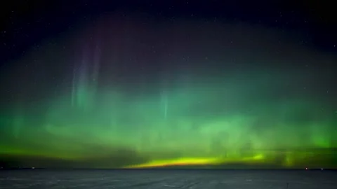 Dramatic Northern Lights, Aurora, above a frozen snow covered lake  Stock Footage 150375690