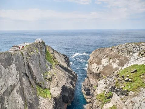 Dramatic ocean cliffs with narrow sea channel Stock Photos