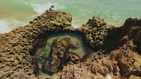 Dramatic ocean cliffs sea caves and tourist boats in Algarve Portugal Stock-Footage 336725624