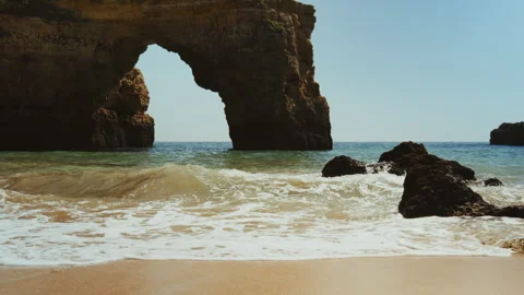 Dramatic ocean cliffs sea caves and tourist boats in Algarve Portugal Video stock 336728071