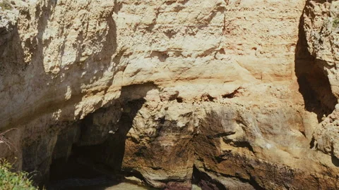 Dramatic ocean cliffs sea caves and tourist boats in Algarve Portugal 스톡 동영상 336728922