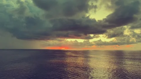 Dramatic ocean scene captures dark clouds and vibrant sunset creating a stu.. Stock Footage 338280345