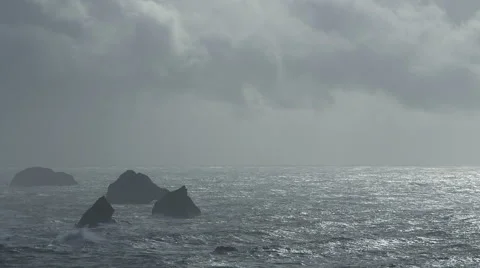 DRAMATIC OCEAN SCENE WITH ROCK OUTCROPPING AND NEGATIVE SPACE Stock Footage 59069919