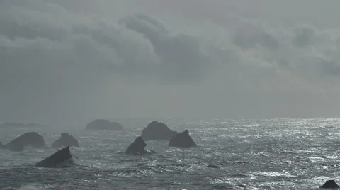 DRAMATIC OCEAN SCENE WITH ROCK OUTCROPPING AND NEGATIVE SPACE; ALT Stock Footage 59070003