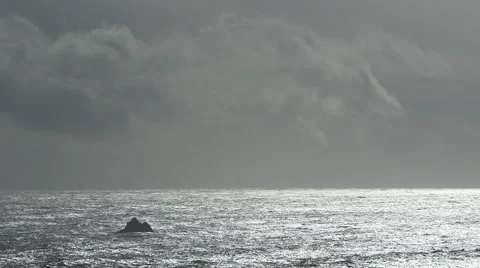 DRAMATIC OCEAN SCENE WITH SOLO ROCK AND NEGATIVE SPACE; ALTERNATE Stock Footage 59069921