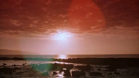 Dramatic Ocean Sunset with Fiery Sky and Silhouetted Rocks 스톡 동영상 327268965