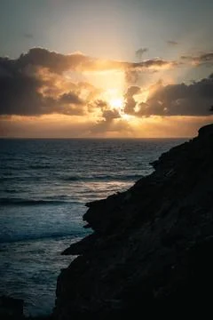 Dramatic Ocean Sunset From Silhouetted Cliff - Portuguese Coast Stock Photos