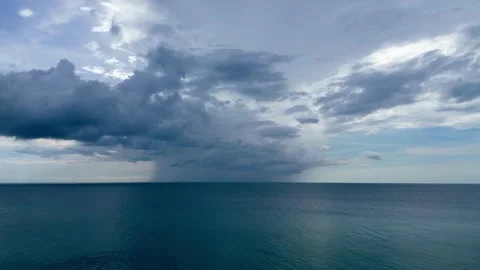 Dramatic ocean view with dark storm clouds gathering on the horizon and raining  Video stock 329743188